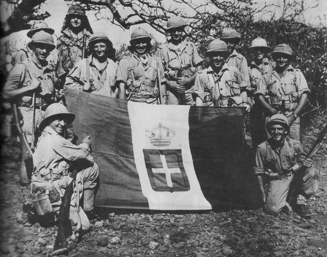 South-African soldiers posing with a captured Italian flag during the East African Campaign, 1941